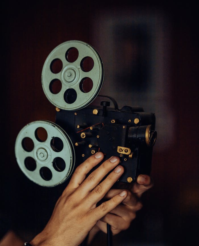 Close-up of a vintage film camera held by hands, exuding a nostalgic and artistic vibe.